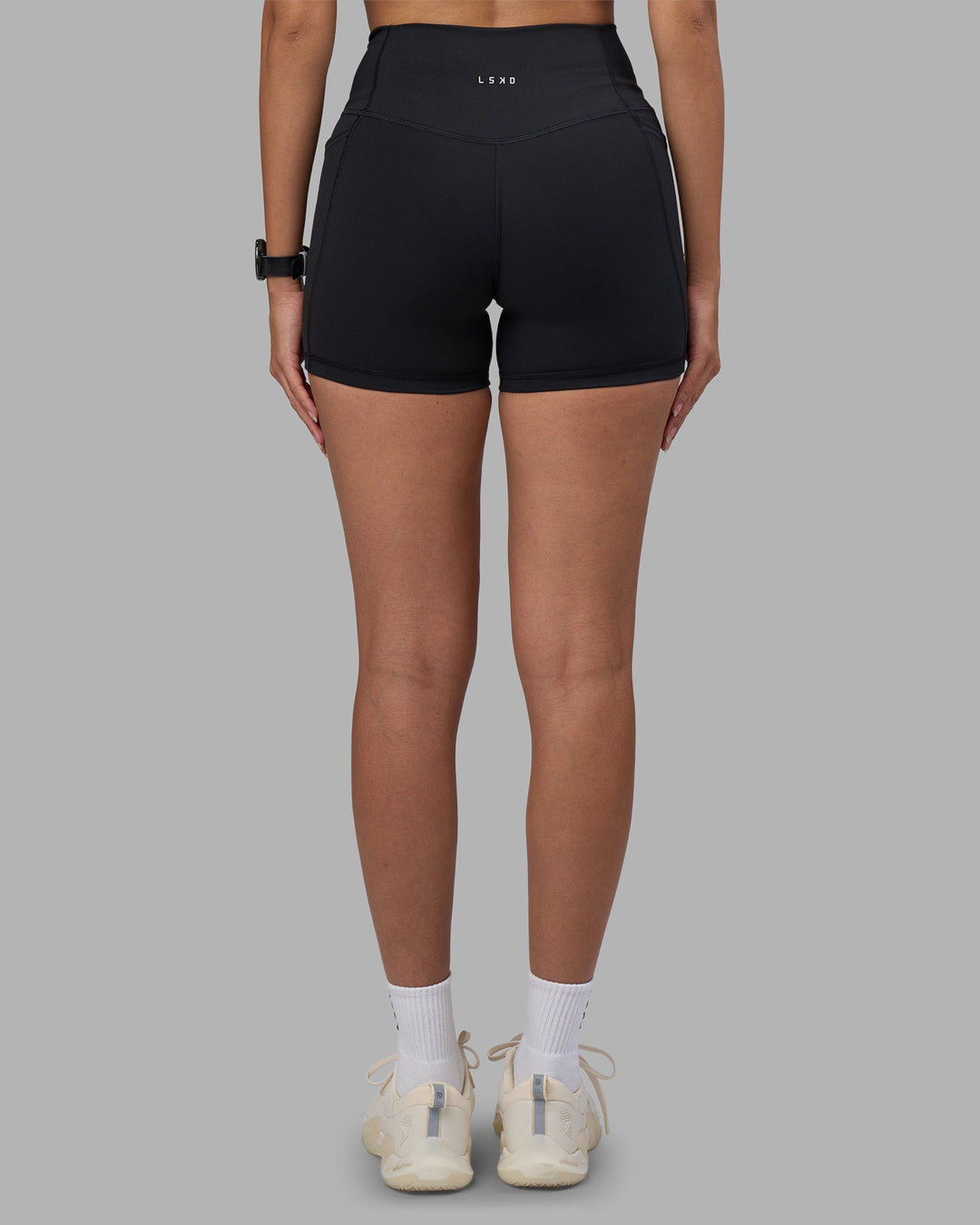 Woman wearing Fusion High-Rise 4" Short Pockets - Black | Model:Rhiley | Size:S