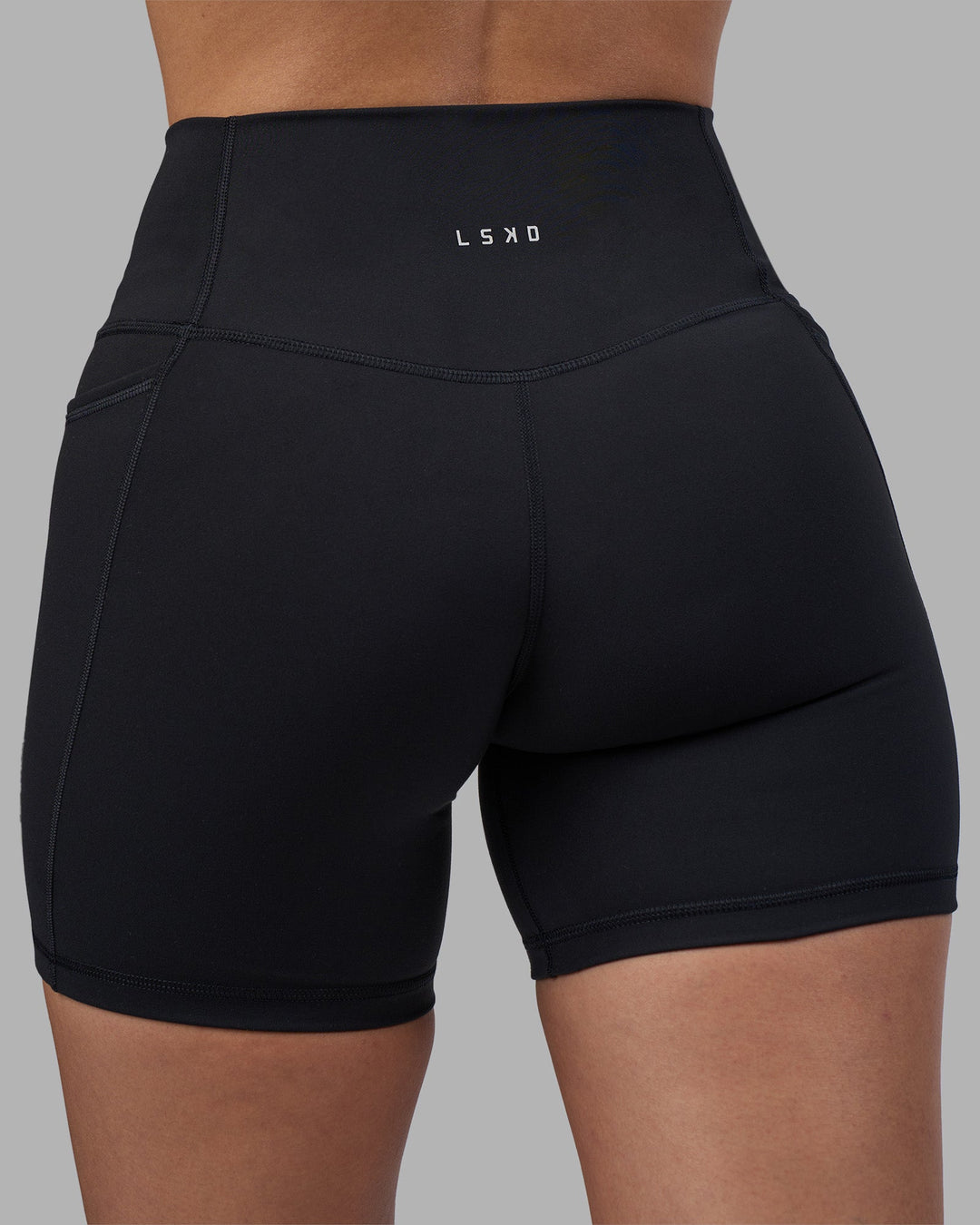 Woman wearing Fusion High-Rise 6" Short Pockets - Black | Model:Rhiley | Size:S