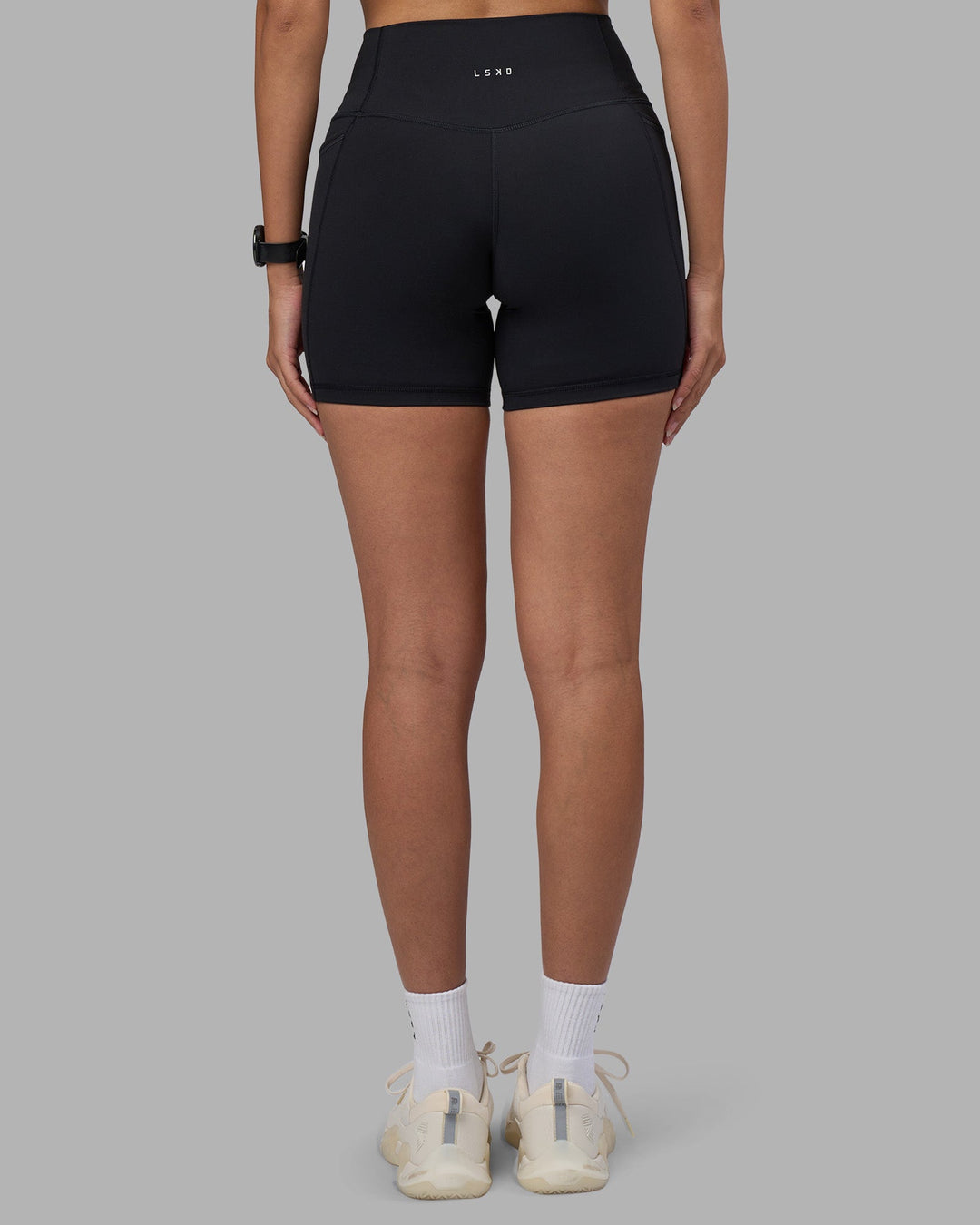 Woman wearing Fusion High-Rise 6" Short Pockets - Black | Model:Rhiley | Size:S