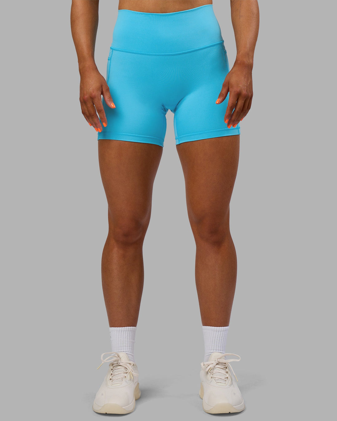 Woman wearing Fusion High-Rise 6" Short Pockets - Blue Atoll | Model:Georgia | Size:S