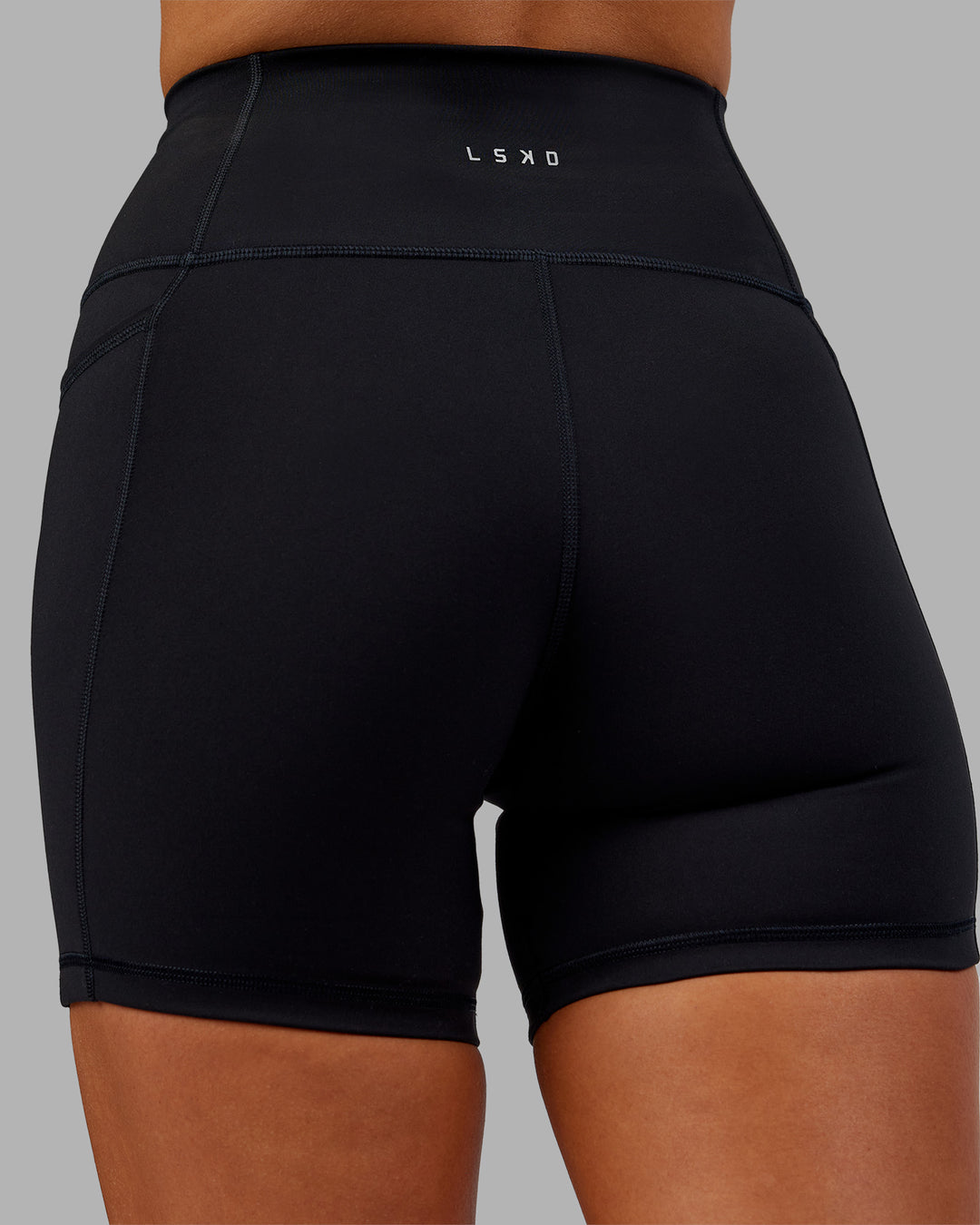 Woman wearing Fusion Ultra High-Rise 6" Short Pockets - Black | Model:Kirstyn | Size:S