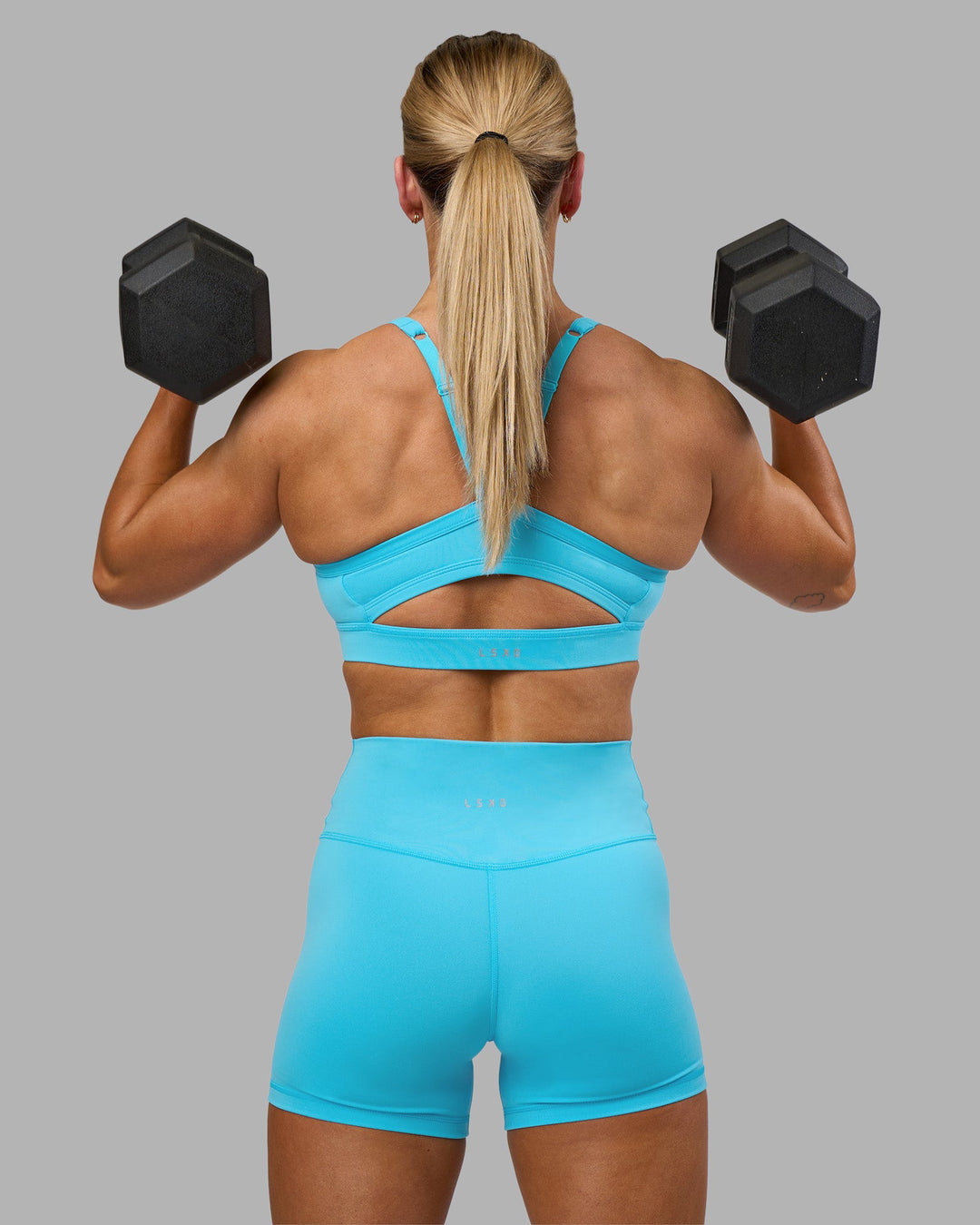 Woman wearing Fusion Ultra High-Rise 4" Short - Blue Atoll | Model:Georgia | Size:S