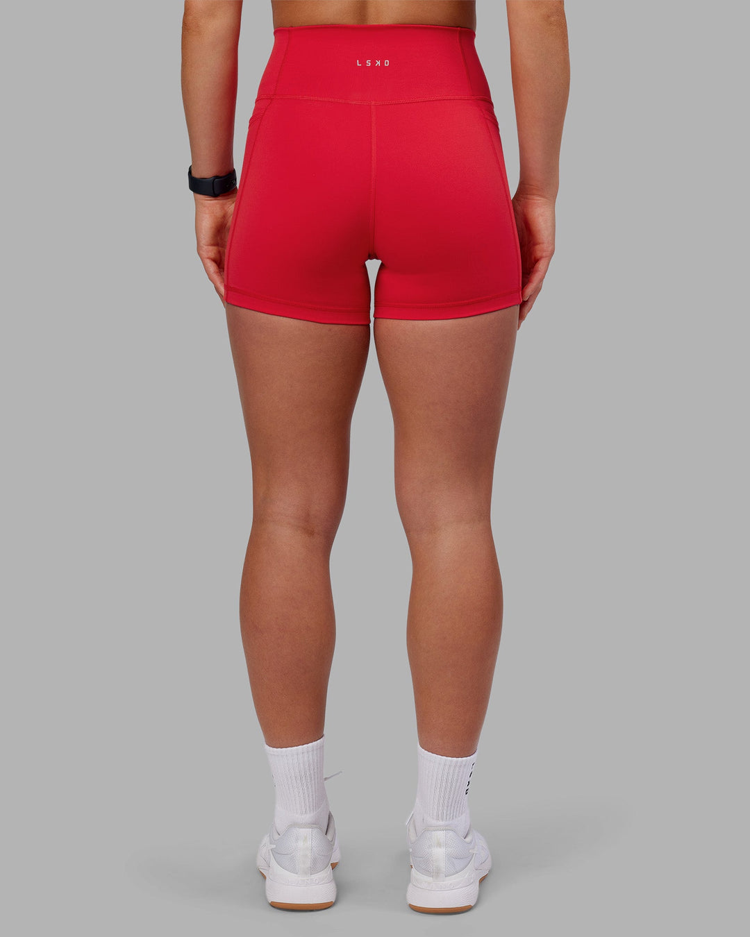 Woman wearing Fusion Ultra High-Rise 4" Short Pockets - Scarlet | Model:Keisha | Size:S