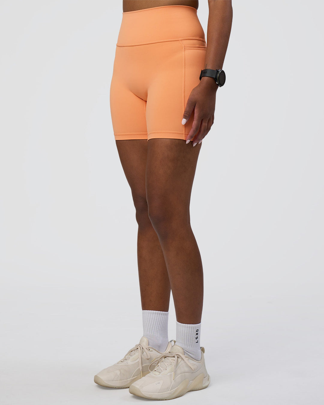 Woman wearing Fusion Ultra High-Rise 6" Short Pockets - Cantaloupe | Model:Rica | Size:S