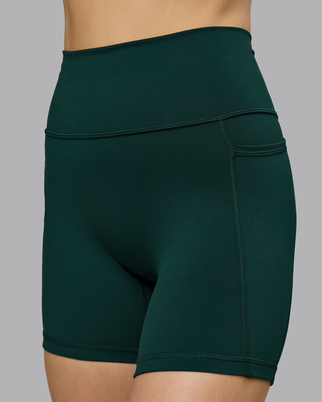 Woman wearing Fusion Ultra High-Rise 6" Short Pockets - Dark Moss | Model:Emilie | Size:S