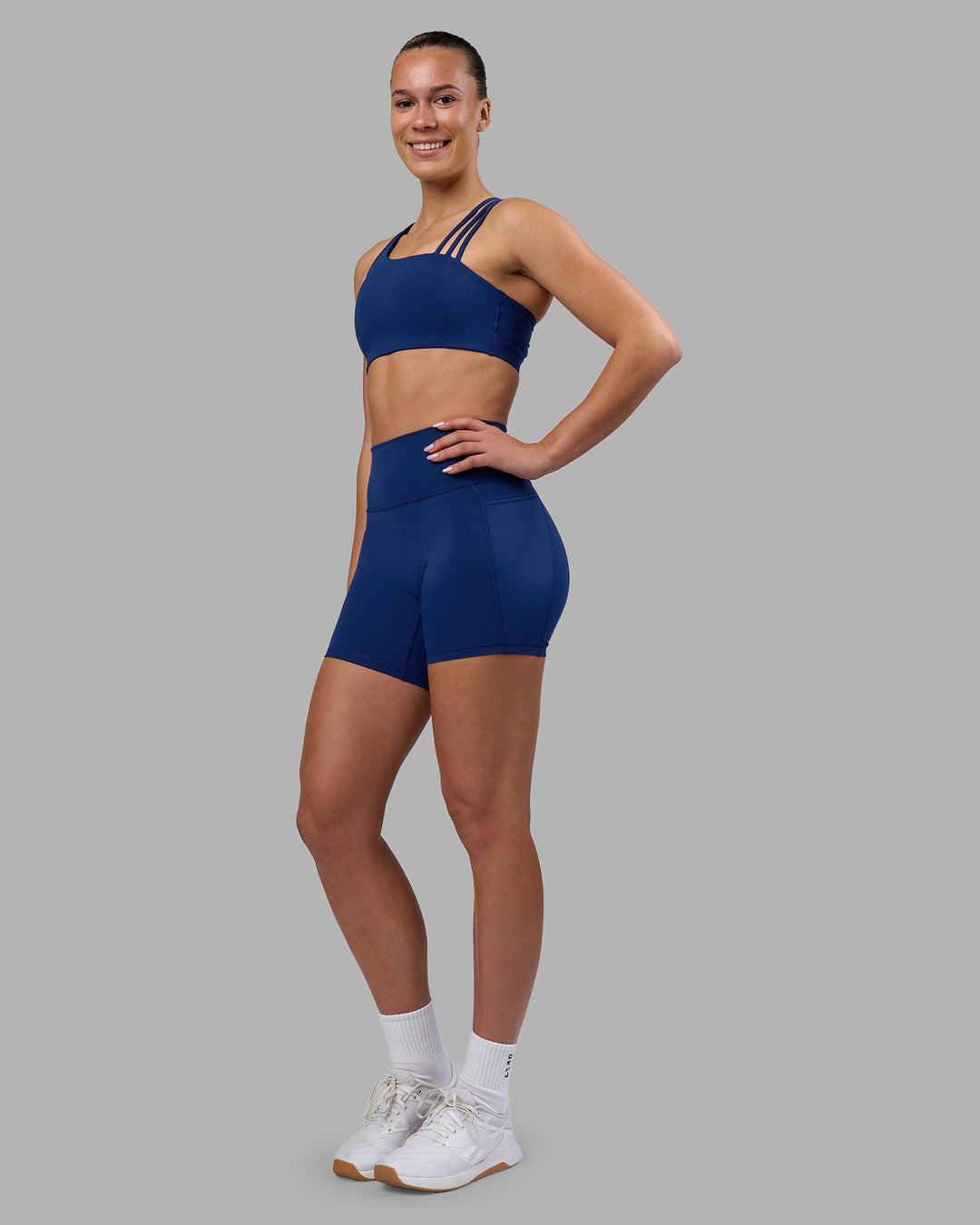 Woman wearing Fusion Ultra High-Rise 6" Short Pockets - Midnight Blue | Model:Charlize | Size:S