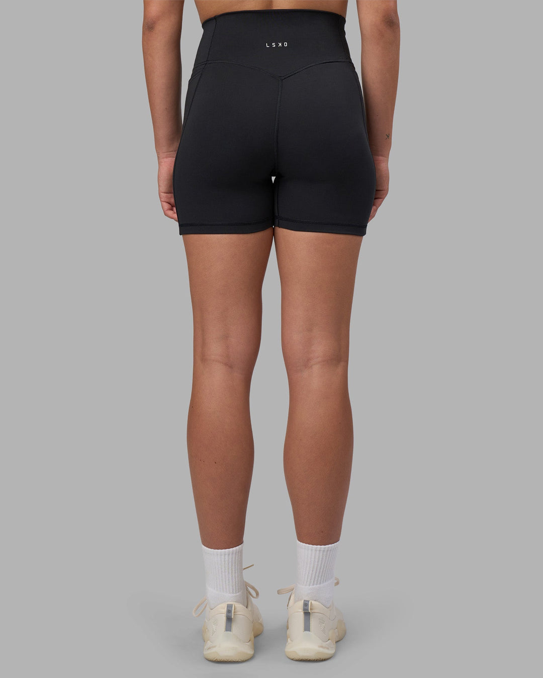Woman wearing Fusion V-Contour Ultra High-Rise 4โ Short Pockets - Black | Model:Charlize | Size:S
