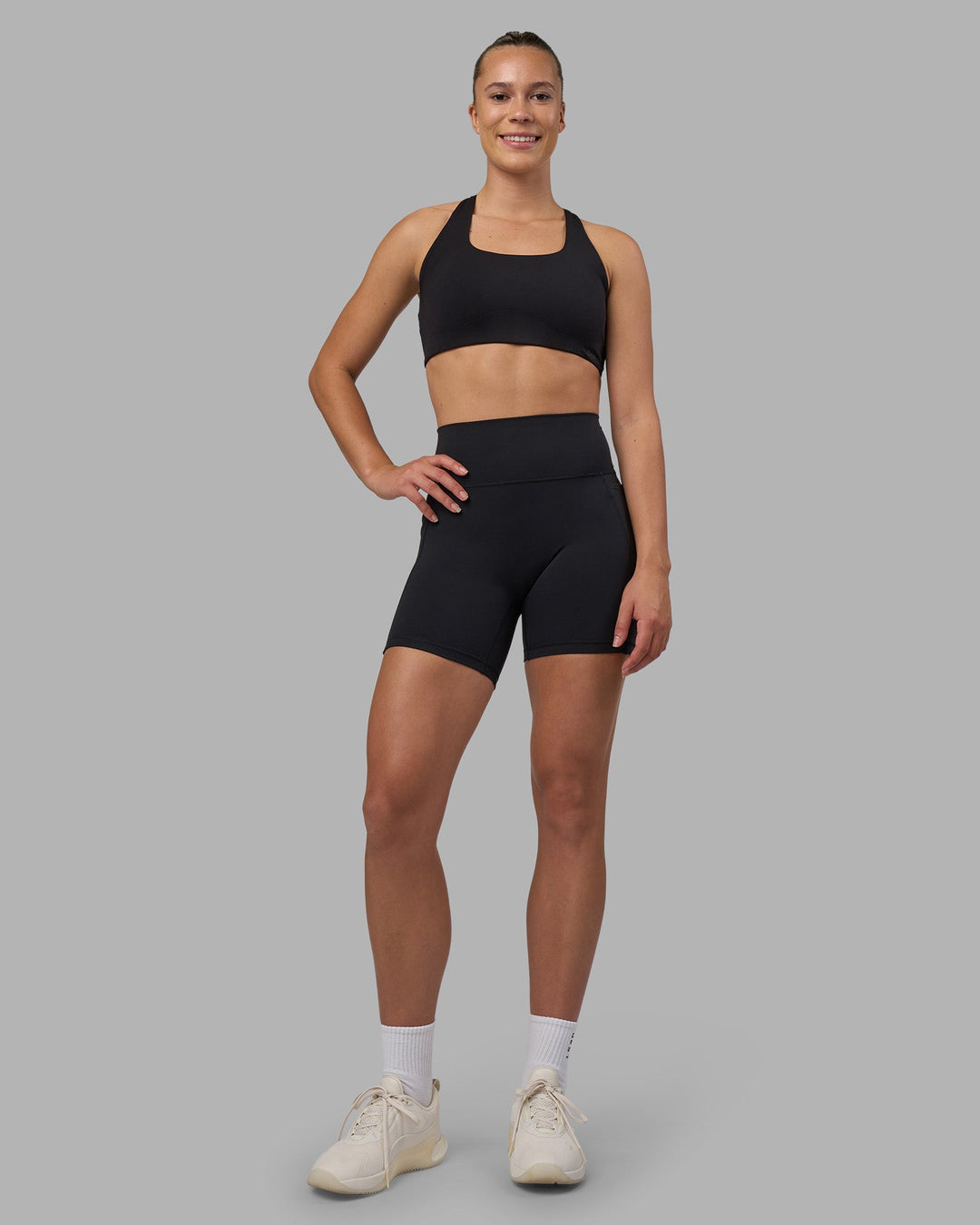 Woman wearing Fusion V-Contour Ultra High-Rise 6" Short Pockets - Black | Model:Charlize | Size:S