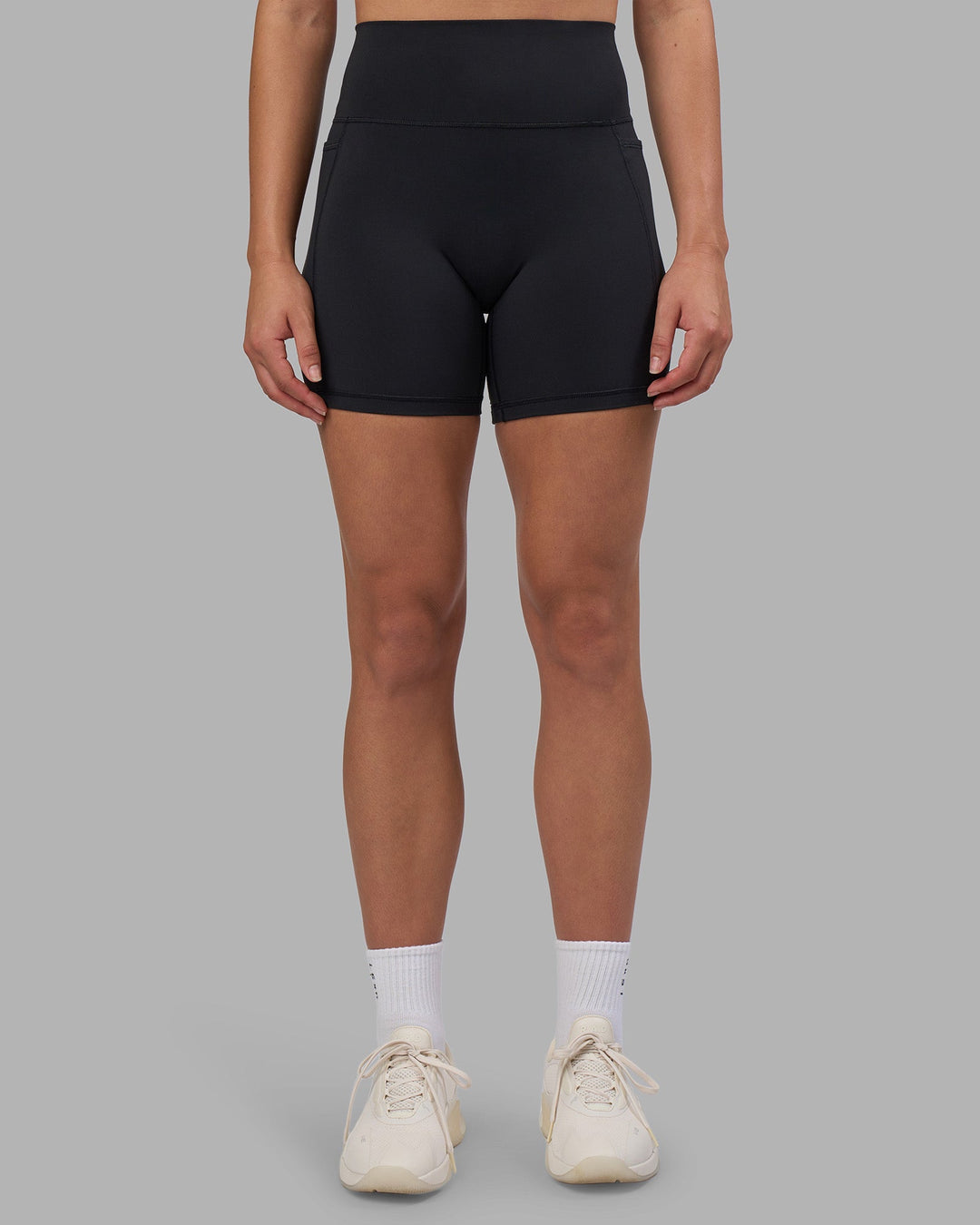 Woman wearing Fusion V-Contour Ultra High-Rise 6" Short Pockets - Black | Model:Charlize | Size:S