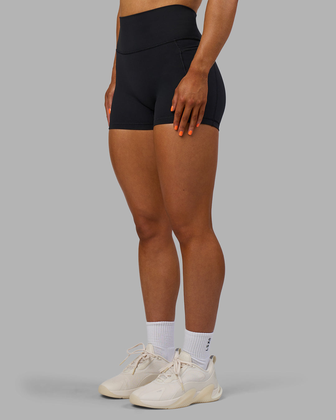 Woman wearing Fusion Ultra High-Rise 4" Short Pockets - Black | Model:Georgia | Size:S
