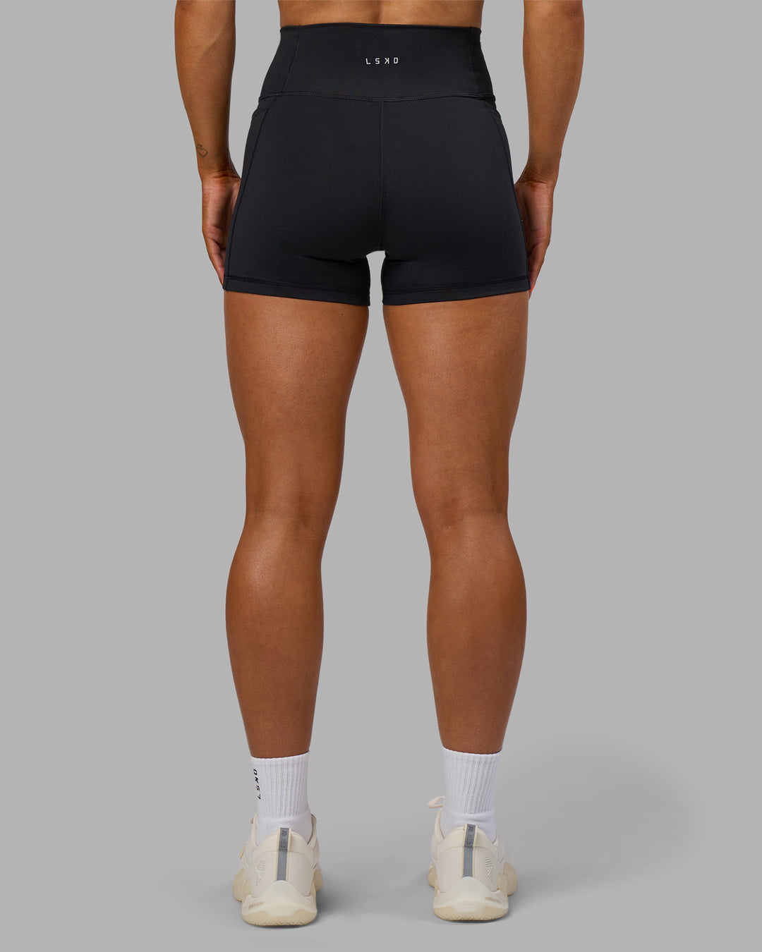 Woman wearing Fusion Ultra High-Rise 4" Short Pockets - Black | Model:Georgia | Size:S