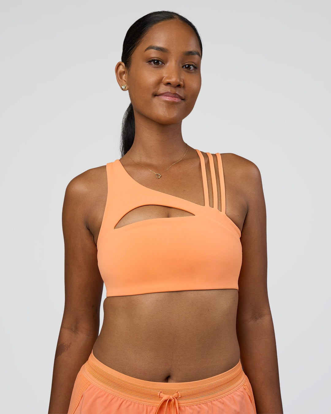 Woman wearing Galvanise Splice Sports Bra - Cantaloupe | Model:Rica | Size:S