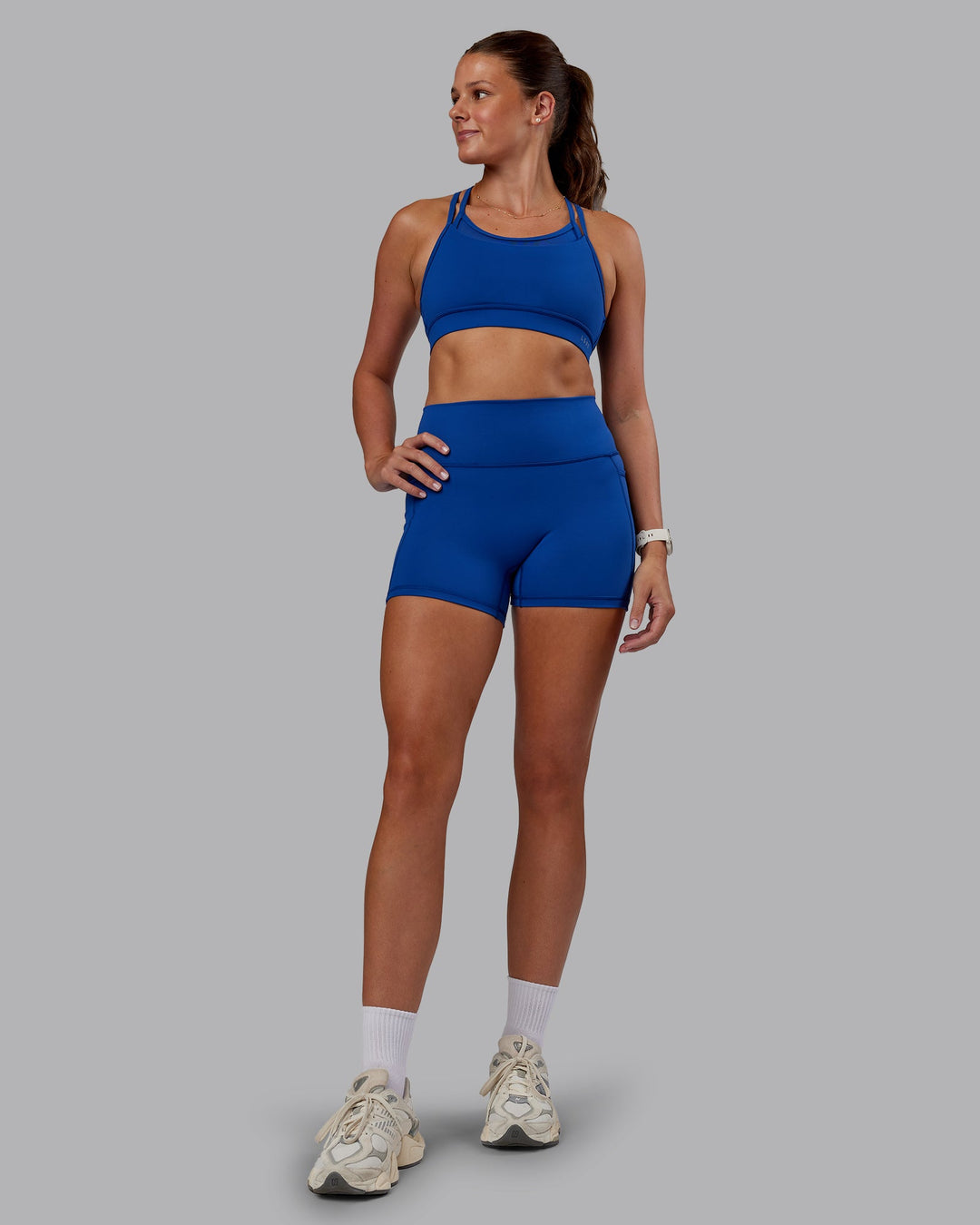 Woman wearing Genesis Layered Sports Bra - Blue Quartz | Model:Phoebe | Size:S