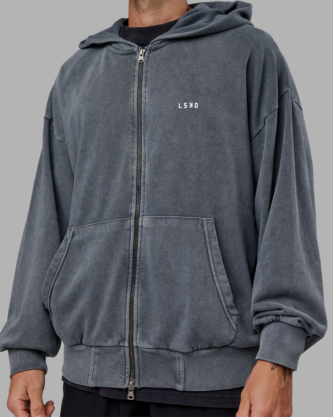 Man wearing Relentless Washed Zip Through Oversized Hoodie - Dark Storm-White | Model:Tommy | Size:S