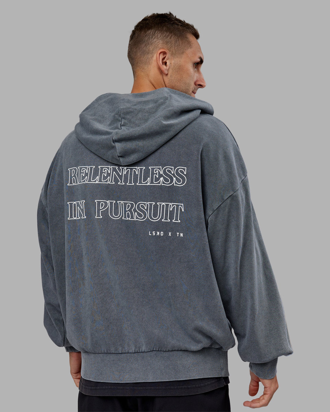 Man wearing Relentless Washed Zip Through Oversized Hoodie - Dark Storm-White | Model:Tommy | Size:S