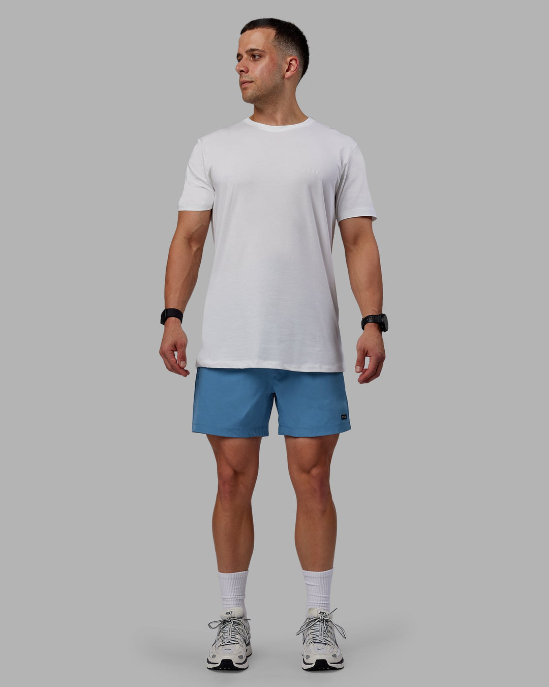 Man wearing Rep 5" Performance Shorts - Elemental Blue