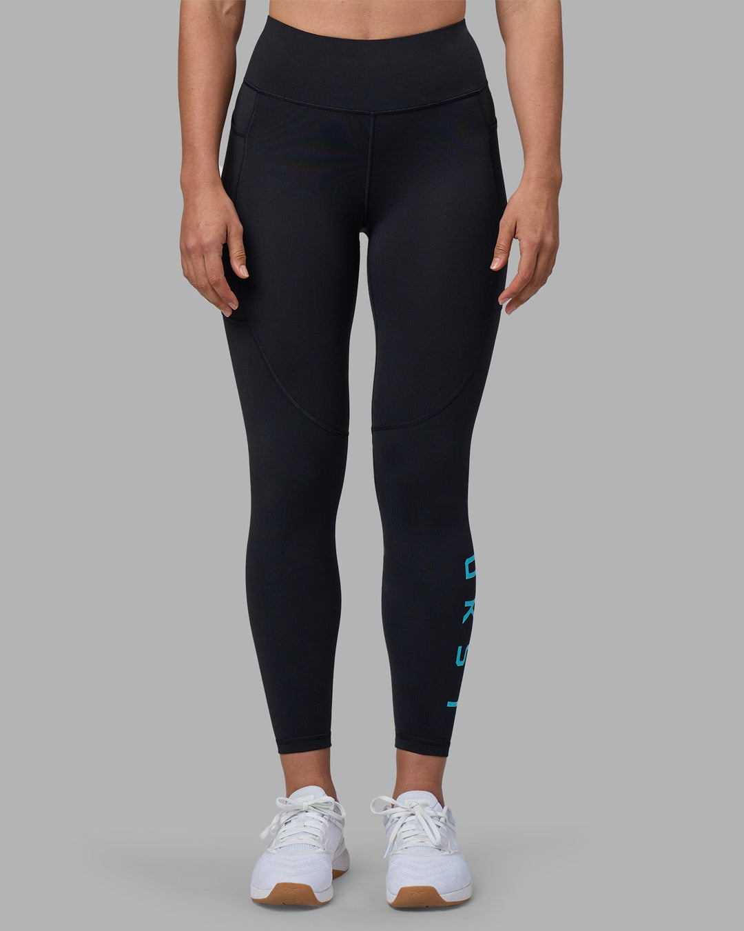 Woman wearing Rep Ultra High-Rise 7/8 Legging Pockets - Black-Blue Atoll | Model:Sophie | Size:S