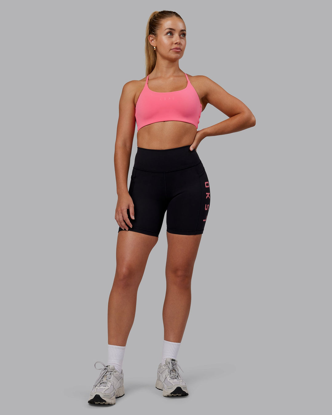 Woman wearing Rep Ultra High-Rise 6" Short Pockets - Black-Pink Lemonade | Model:Hannah | Size:S