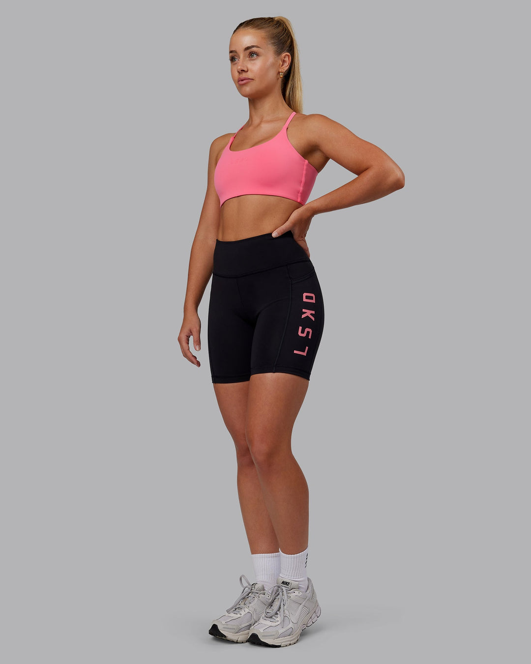 Woman wearing Rep Ultra High-Rise 6" Short Pockets - Black-Pink Lemonade | Model:Hannah | Size:S