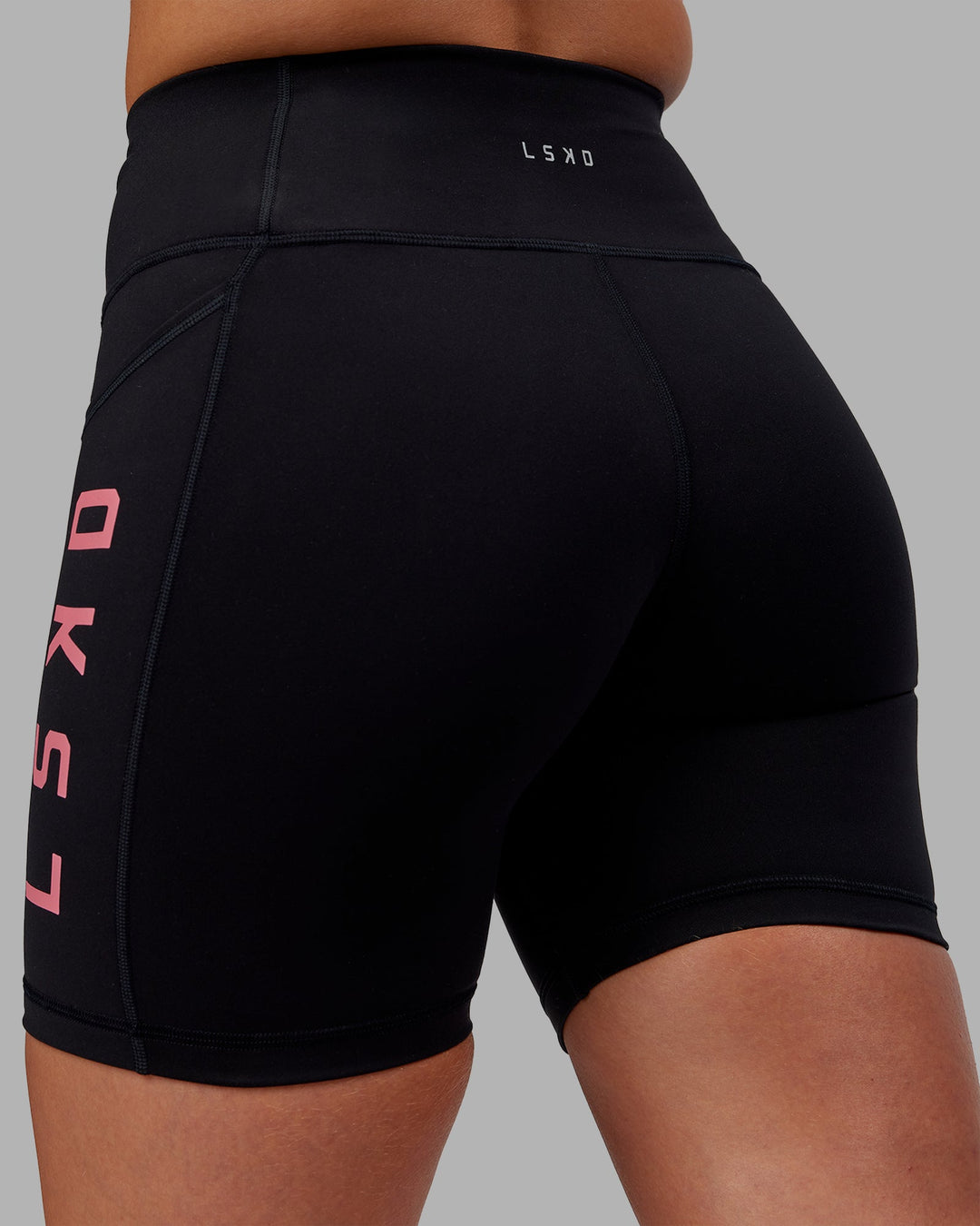Woman wearing Rep Ultra High-Rise 6" Short Pockets - Black-Pink Lemonade | Model:Hannah | Size:S