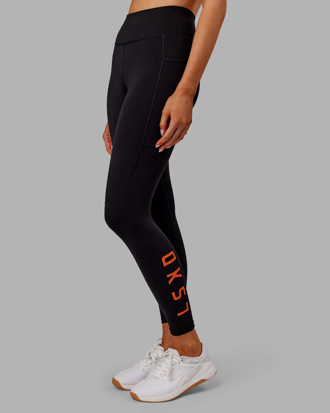 Woman wearing Rep Ultra High-Rise 7/8 Legging Pockets - Black-Ultra Orange | Model:Ella | Size:S