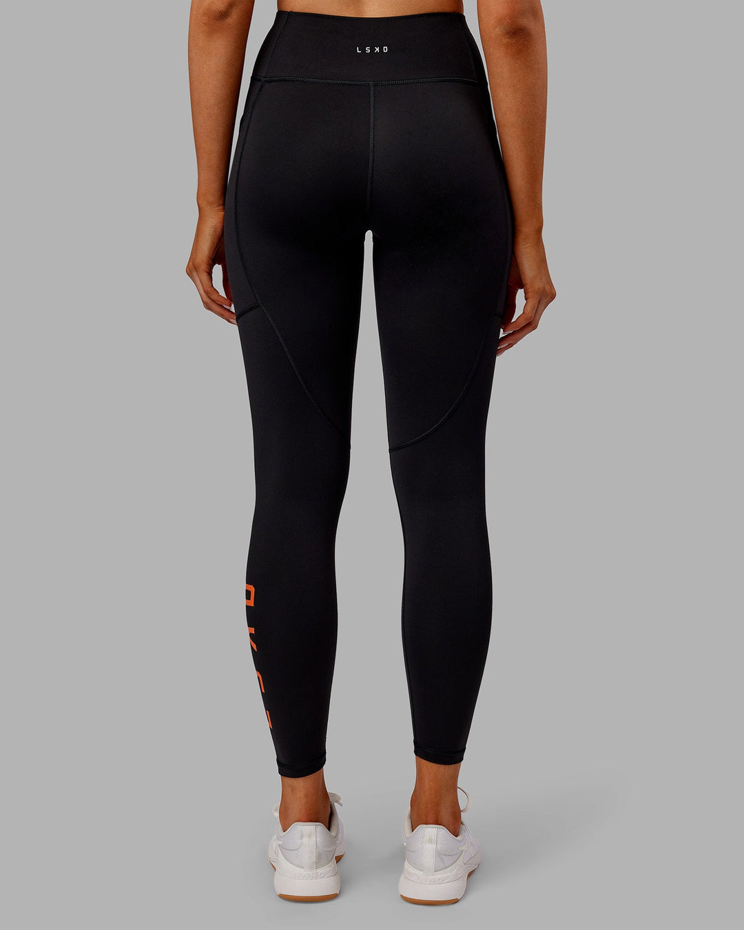 Woman wearing Rep Ultra High-Rise 7/8 Legging Pockets - Black-Ultra Orange | Model:Ella | Size:S