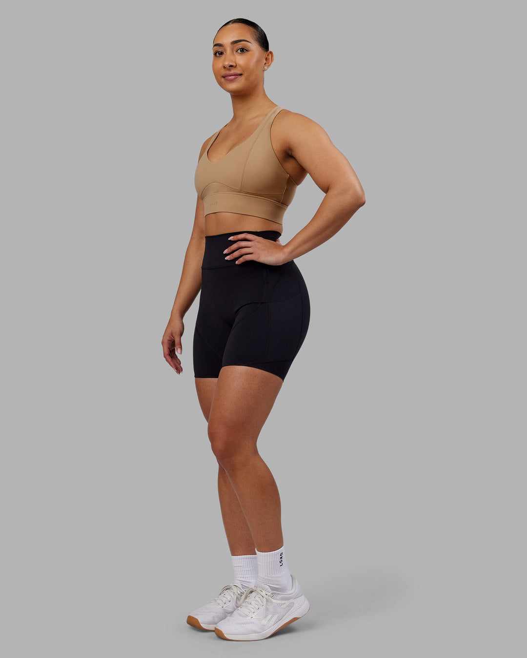 Woman wearing Rhythm Elixir Ultra High-Rise 6" Short Pockets - Black | Model:Ayla | Size:S