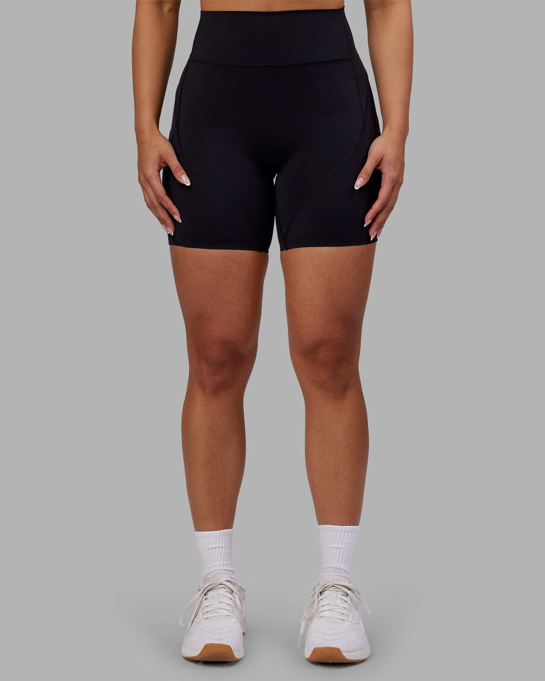 Woman wearing Rhythm Elixir Ultra High-Rise 6" Short Pockets - Black | Model:Ayla | Size:S