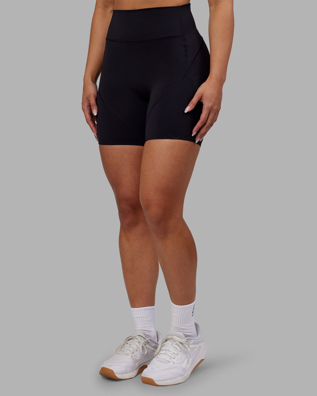Woman wearing Rhythm Elixir Ultra High-Rise 6" Short Pockets - Black | Model:Ayla | Size:S