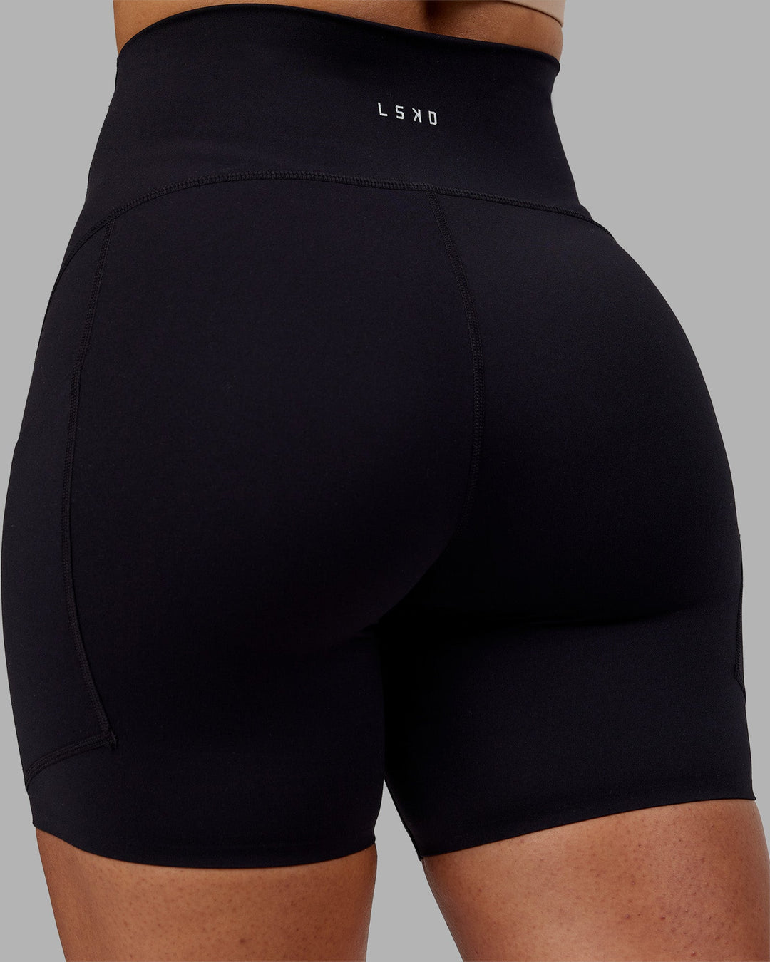 Woman wearing Rhythm Elixir Ultra High-Rise 6" Short Pockets - Black | Model:Ayla | Size:S