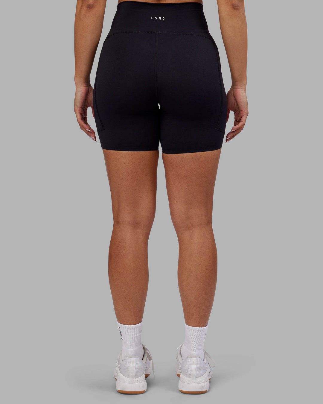 Woman wearing Rhythm Elixir Ultra High-Rise 6" Short Pockets - Black | Model:Ayla | Size:S