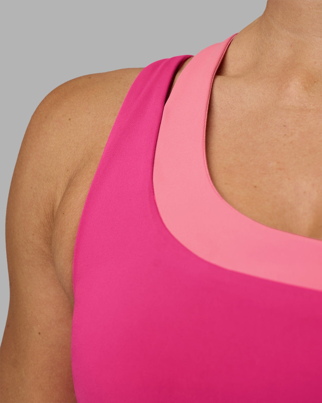 Woman wearing Thrive Asymmetric Sports Bra - Ultra Pink-Candy Pink | Model:Hannah | Size:S