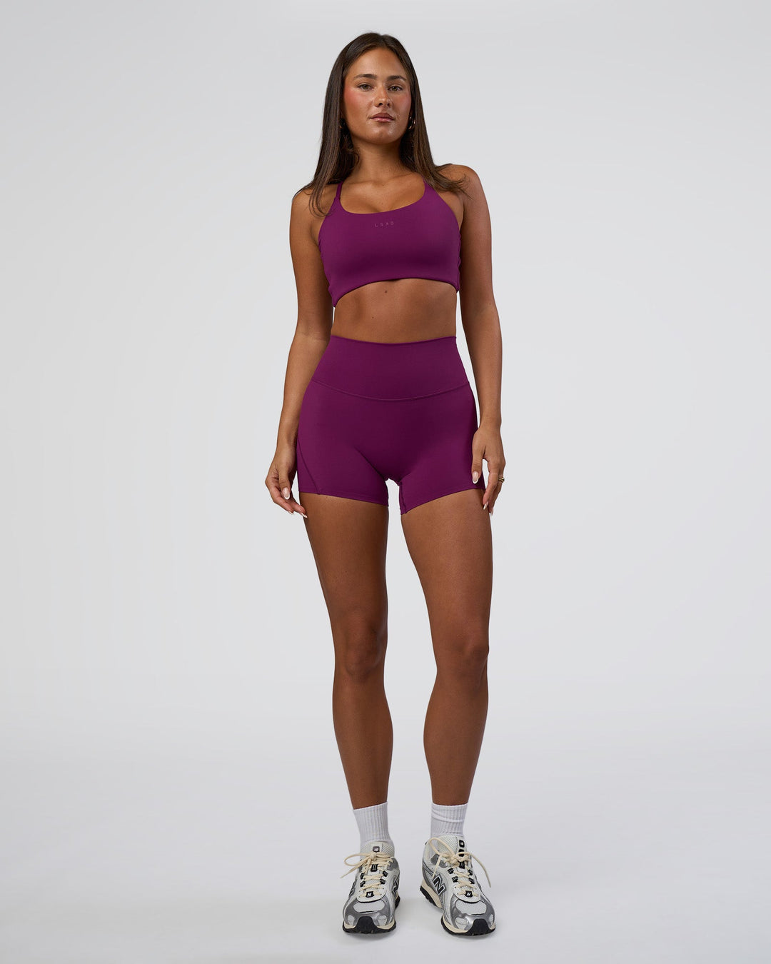 Woman wearing Twist Sports Bra - Plum Caspia | Model:Bianca | Size:S
