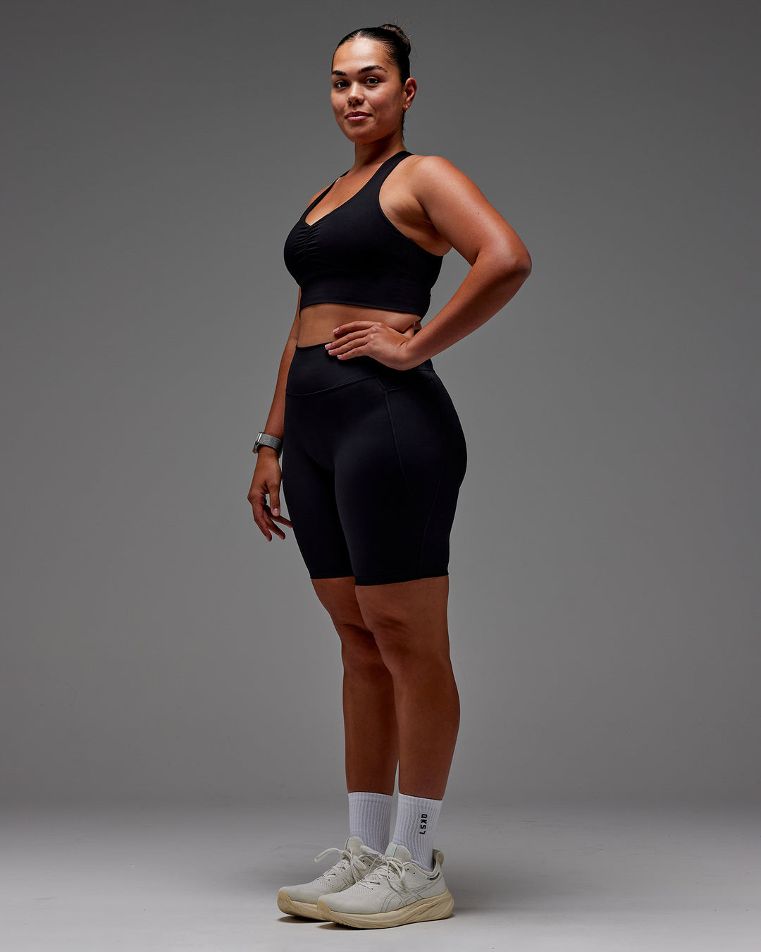 Woman wearing Fusion Ultra High-Rise 9" Short Pockets - Black | Model:Aimee | Size:XL