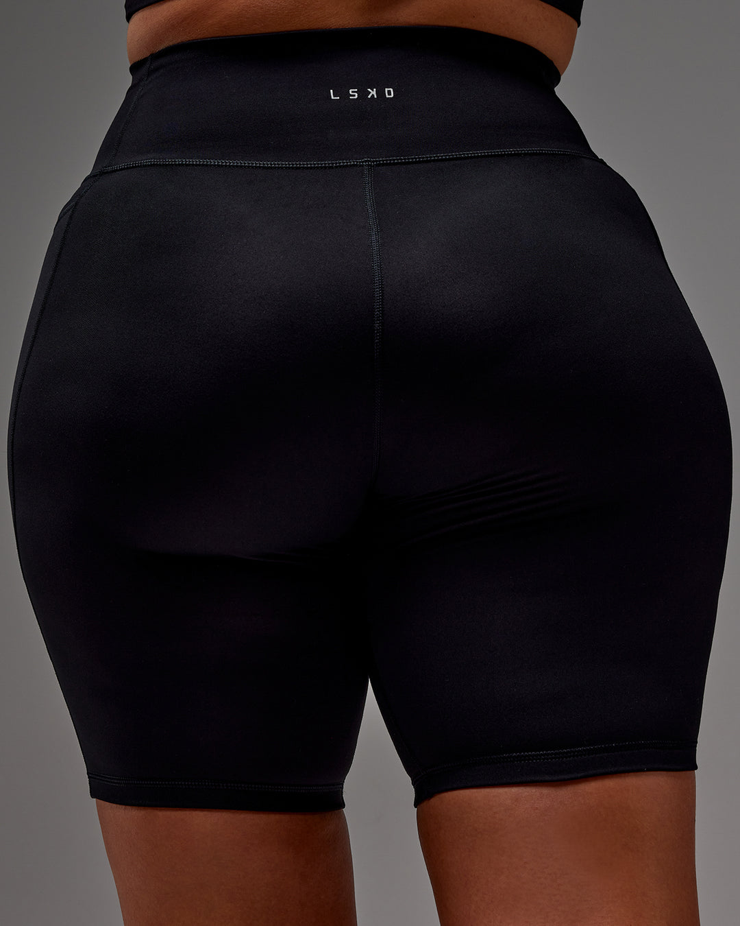 Woman wearing Fusion Ultra High-Rise 9" Short Pockets - Black | Model:Aimee | Size:XL
