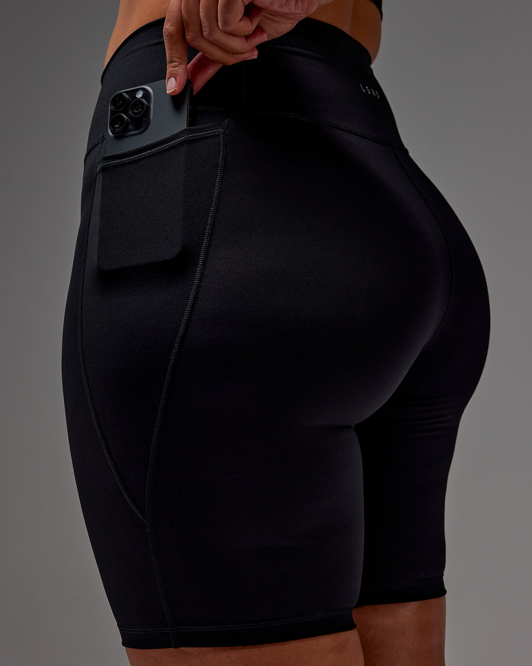 Woman wearing Fusion Ultra High-Rise 9" Short Pockets - Black | Model:Aimee | Size:XL