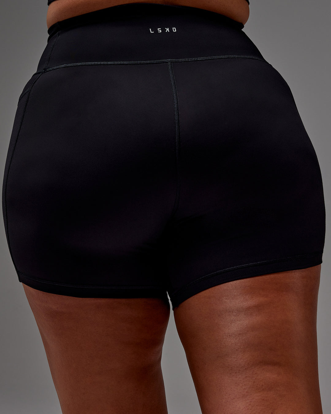 Woman wearing Fusion Ultra High-Rise 6" Short Pockets - Black | Model:Aimee | Size:XL