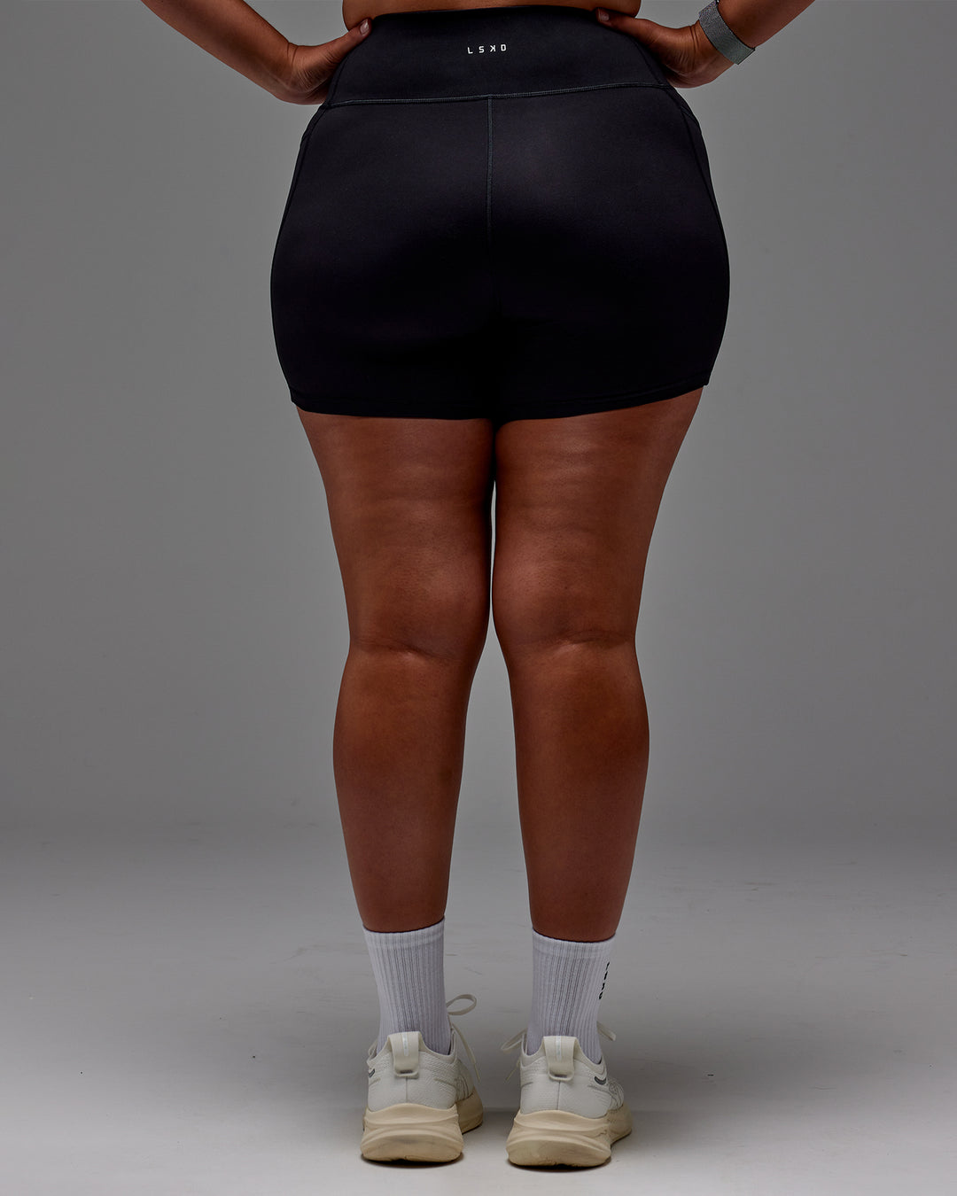 Woman wearing Fusion Ultra High-Rise 6" Short Pockets - Black | Model:Aimee | Size:XL