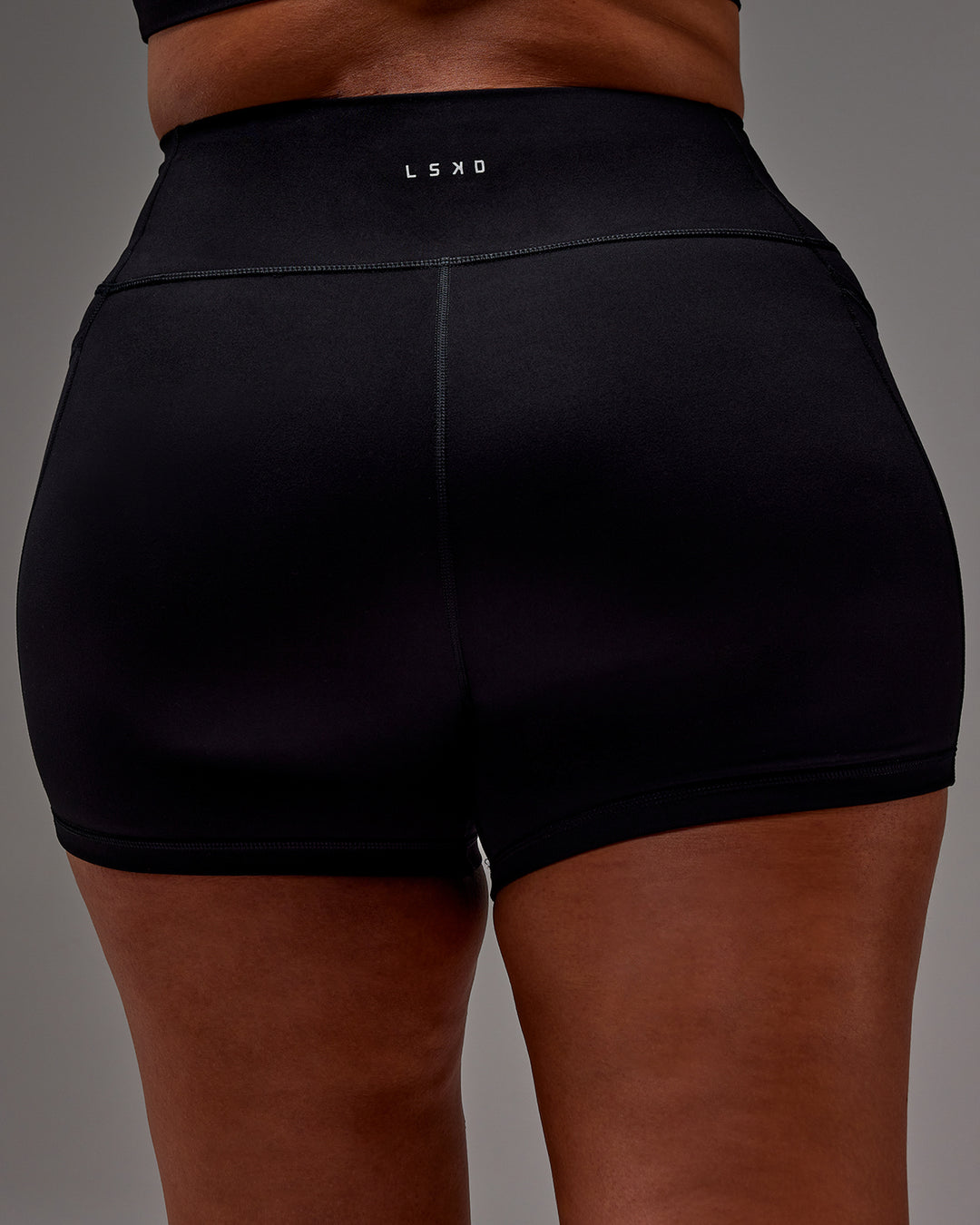 Woman wearing Fusion Ultra High-Rise 4" Short Pockets - Black | Model:Aimee | Size:XL