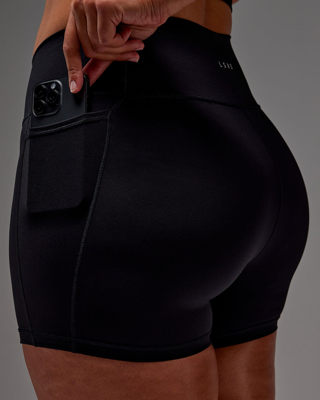 Woman wearing Fusion Ultra High-Rise 4" Short Pockets - Black | Model:Aimee | Size:XL