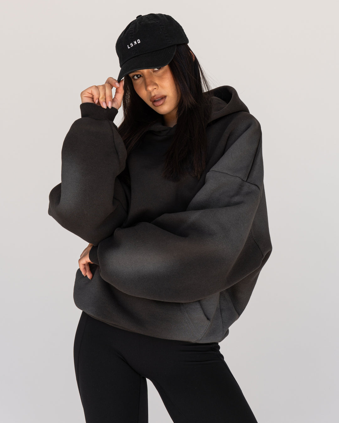 Woman wearing Memory In Motion 500gsm Ultra Heavyweight Washed Hoodie - Charcoal Washed | Model:Eliza | Size:XS