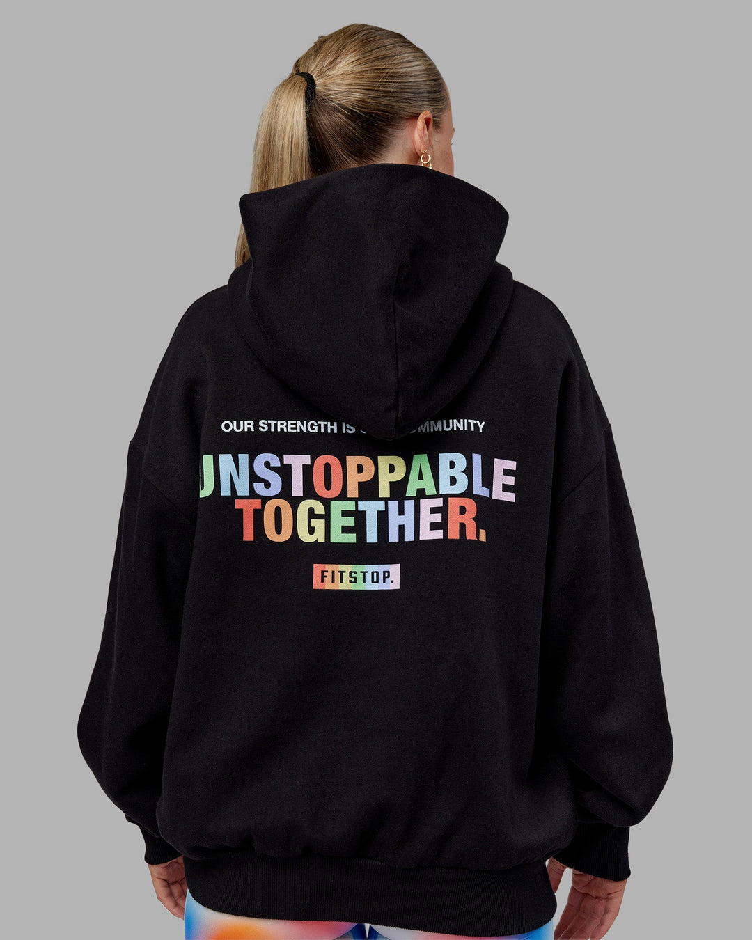 Woman wearing Fitstop Unstoppable Together Oversized Hoodie - Black | Model:Neve | Size:XS