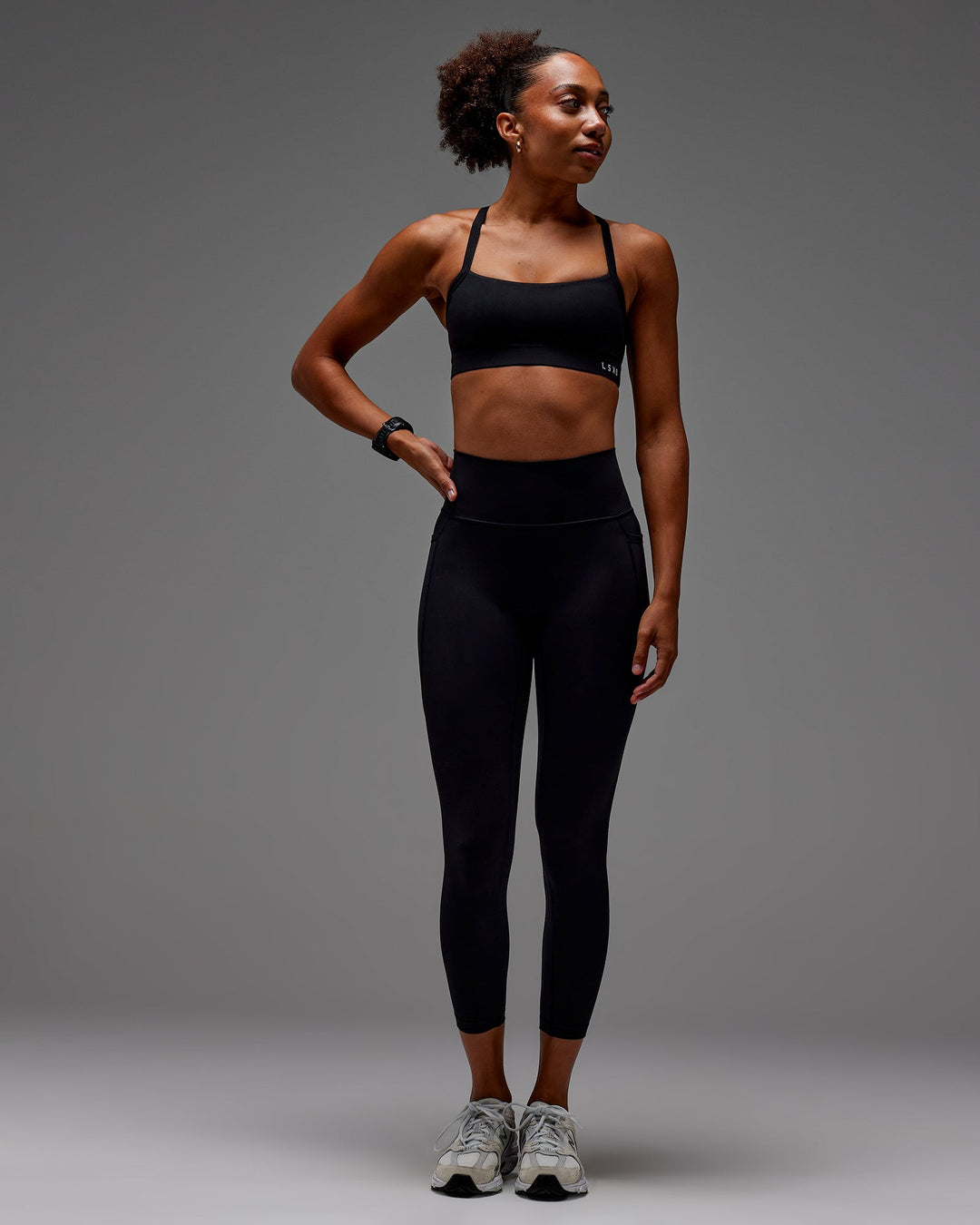 Woman wearing Fusion Ultra High-Rise 7/8 Legging Pockets - Black | Model:Txai | Size:XS