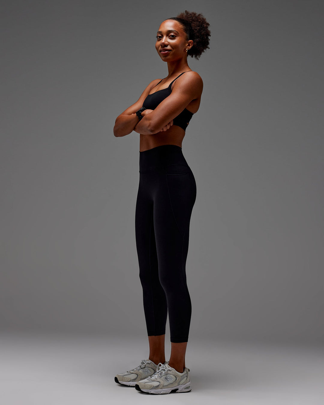 Woman wearing Fusion Ultra High-Rise 7/8 Legging Pockets - Black | Model:Txai | Size:XS