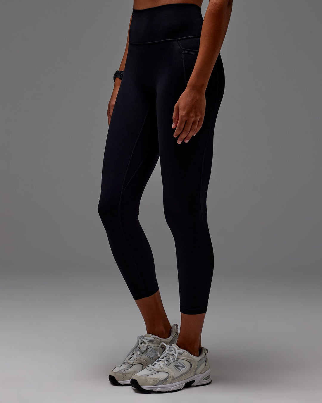 Woman wearing Fusion Ultra High-Rise 7/8 Legging Pockets - Black | Model:Txai | Size:XS