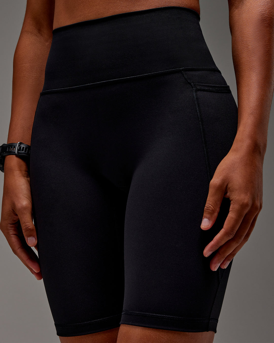 Woman wearing Fusion Ultra High-Rise 9" Short Pockets - Black | Model:Txai | Size:XS