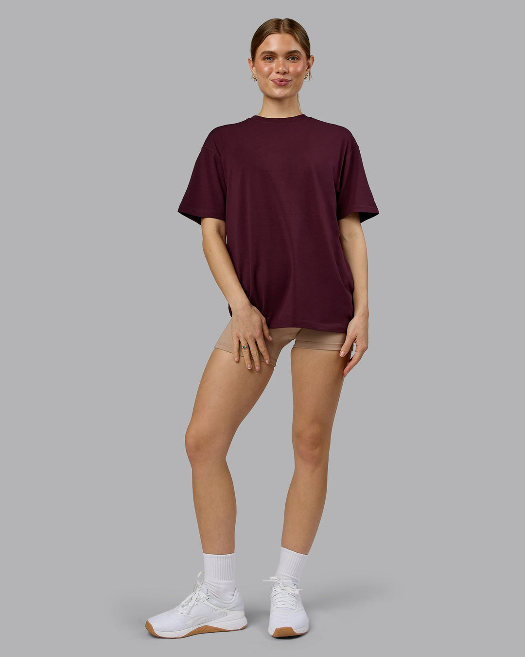 Woman wearing Lifting Club FLXCotton Tee Oversize - Cherry Lacquer-White | Model:Emilie | Size:XS