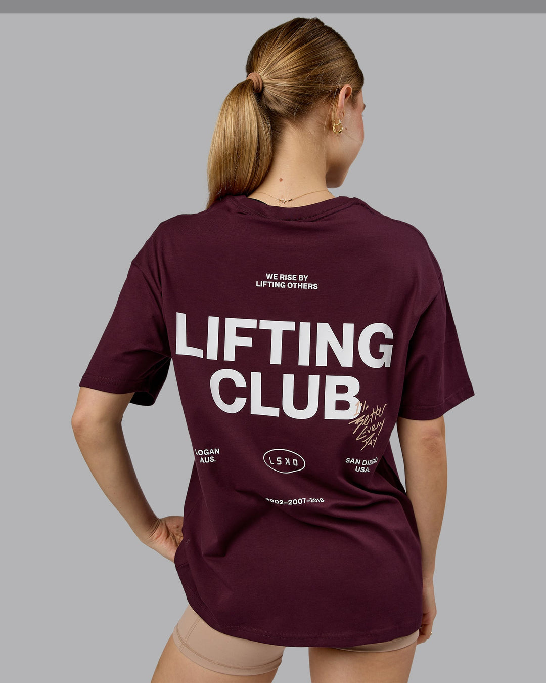 Woman wearing Lifting Club FLXCotton Tee Oversize - Cherry Lacquer-White | Model:Emilie | Size:XS