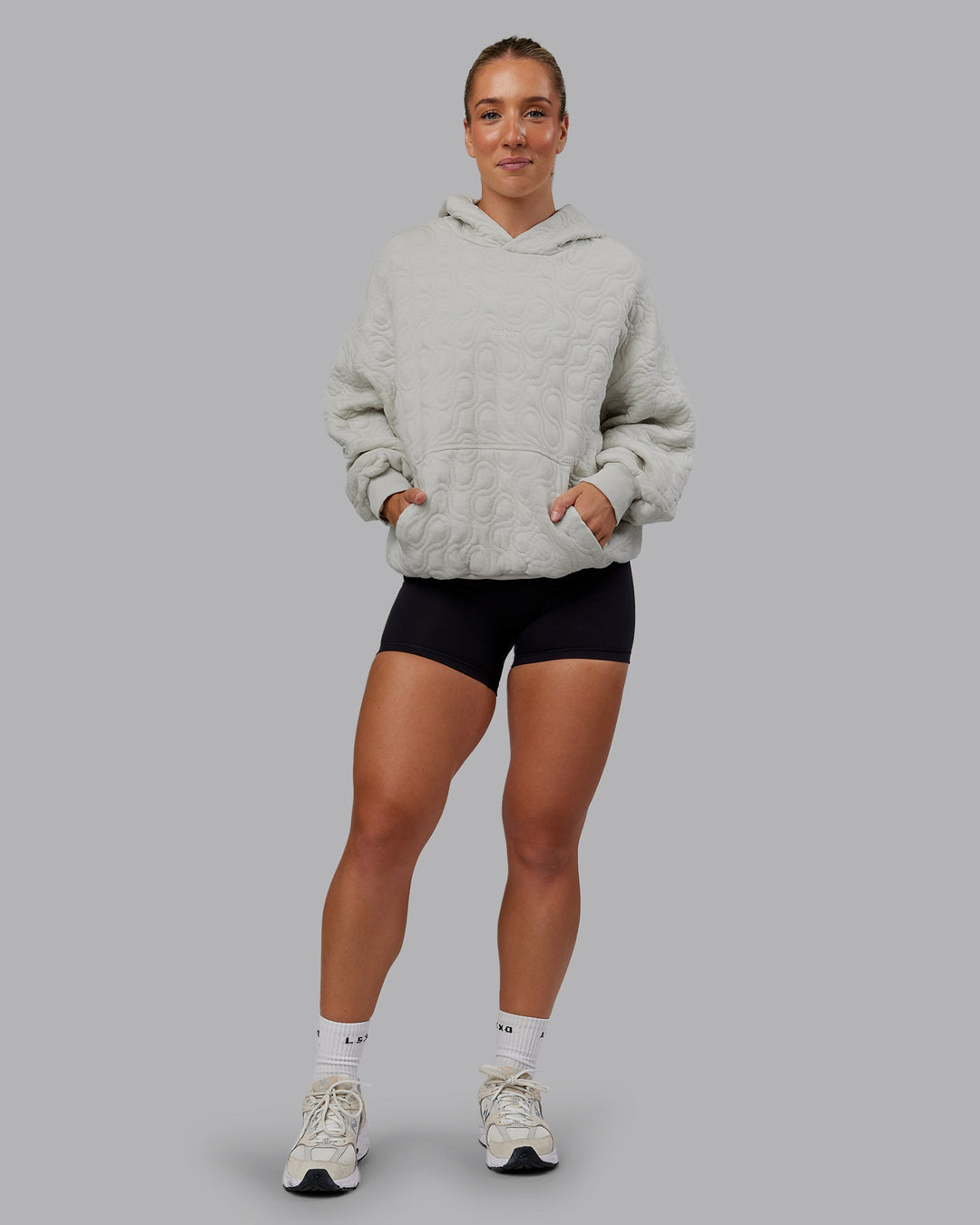 Woman wearing MVP Quilted Oversized Hoodie - Digital Mist-Geometric | Model:Lyss | Size:XS