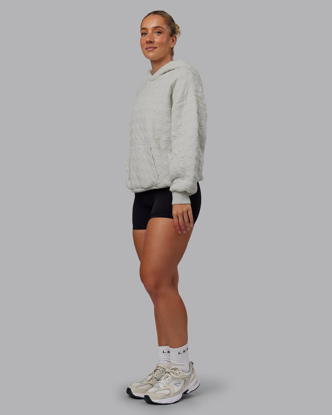 Woman wearing MVP Quilted Oversized Hoodie - Digital Mist-Geometric | Model:Lyss | Size:XS
